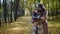 embrace of heterosexual loving couple in autumn park, man is hugging his girlfriend