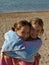 Embraced sisters on beach
