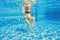 Embracing aquatic fitness, a pregnant woman demonstrates strength and serenity in underwater aerobics, creating a serene