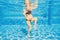 Embracing aquatic fitness, a pregnant woman demonstrates strength and serenity in underwater aerobics, creating a serene