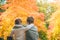 Embracing brothers sitting in autumn forest