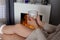 Embracing Winter Warmth: Young Woman Enjoys Cozy Moments by the Fireplace