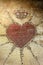 Embroidered heart and heraldic crown on tapestry