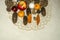 Embroidered napkin with gifts for Christmas from apple,almonds,tangerines,nuts,Christmas toys with coniferous cones on plywood