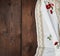 Embroidered white dishcloth with lace on a brown wooden background