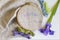 Embroidery with green, light blue and violet embroidery floss with needle on wooden hoops on linen fabric