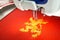 Embroidery machine and gold lion design on red cotton fabric shirt, close up picture