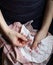 Embroidery in woman hands, female doing flower pattern embroidery on children natural clothes