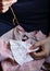 Embroidery in woman hands, female doing flower pattern embroidery on grandma natural clothes