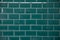 Emerald bricks. Brick type tile with white seams. Bricks are laid out in even repeating rows.