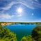 emerald calm lake at the summer sunny day