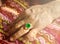 Emerald with diamonds decoration ring in Asian lady`s finger.
