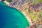 Emerald hidden beach under Biokovo mountain cliffs aerial view