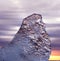 Emerald ice floes on a rocky volcanic beach at sunset. Glacial Lagoon.