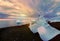 Emerald ice floes on a rocky volcanic beach at sunset. Glacial Lagoon. Iceland.Long exposure.