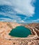 Emerald lake in a flooded quarry. Emerald green lake in flooded opencast mine, open pit. Oval lake in mining industrial crater,