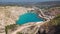 Emerald lake in a flooded quarry. Emerald green lake in flooded opencast mine. Oval lake in mining industrial crater