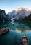 Emerald Mountain Lake Braies. boat station. Wooden pier. Morning landscape in Italy