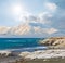 Emerald sea bay and snowbound mountain