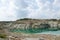 Emerald water at the foot of chalk sheer walls of the quarry