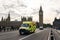 Emergency Ambulance van speeds along a street in London near Big Ben