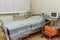 Emergency area in the clinic. Light sterile recovery room with bed. The light is on. Ambulance box. Medical equipment. Trolley for