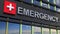 Emergency department building sign closeup, with sky