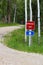 Emergency exit sign along a country road with another same sign blurred in the background