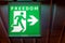 The emergency exit sign indicates the direction of way to freedom