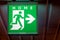 The emergency exit sign indicates the direction of way to home