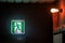 The emergency exit sign shows the direction of escape in case of danger