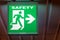 The emergency exit sign shows the direction of safety.