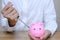 Emergency finance and Reserve money concept, Businessman using tools to destroy pink piggy bank
