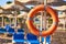 Emergency orange life buoy on sea beach