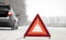 Emergency red sign on a snow-covered road.Car breakdown on the highway.