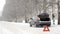 Emergency red sign on a snow-covered road.Car breakdown on the highway.