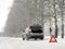 Emergency red sign on a snow-covered road.Car breakdown on the highway.