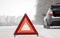 Emergency red sign on a snow-covered road.Car breakdown on the highway.