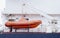 Emergency rescue orange inflatable dinghy boat on ship cruise
