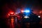 Emergency response Police cars chase through the fog at night