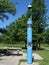 An emergency station to call a police in the form of a tall illuminated pedestal located in