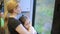 Emigrants mother and daughter looking in the window of the train