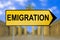 Emigration traffic sign with blurred Berlin background