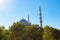 Eminonu Yeni Cami or New Mosque with autumn colored trees.