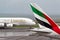 Emirates Airlines Airbus A380 aircraft taxis past the tail of Emirates airlines Boeing 777 aircraft.