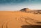 Emirati Desert Landscape with Mountain in Background and Curved Tire-Tracks in Foreground