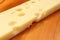 Emmental cheese on wooden board, shallow DOF