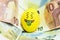 Emoji Easter egg with facial expression `I love money` placed on euro paper money