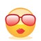 Emoji of a face of a lady with glasses