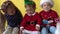 Emotion Cute Happy 3 Siblings Friend Baby Girl And Boy Wave Feet In Santa Suit Looking On Camera At Yellow Background